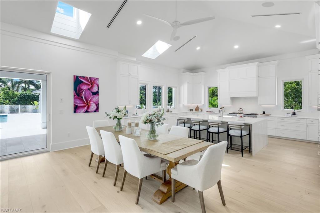 3136 Ravenna Avenue Naples, FL 34120 - Photo 25 of 50 Dining room featuring light wood-type flooring, recessed lighting, a ceiling fan, a skylight, and vaulted ceiling