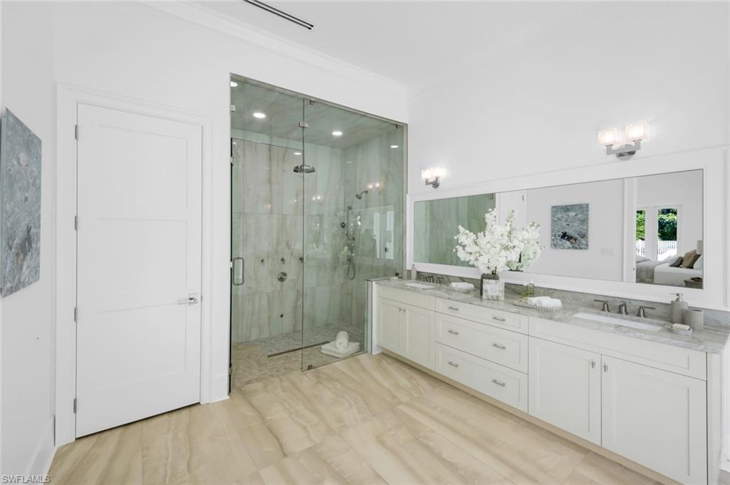 3136 Ravenna Avenue Naples, FL 34120 - Photo 30 of 50 Full bathroom featuring double vanity, a shower stall, ensuite bathroom, and light wood-style floors