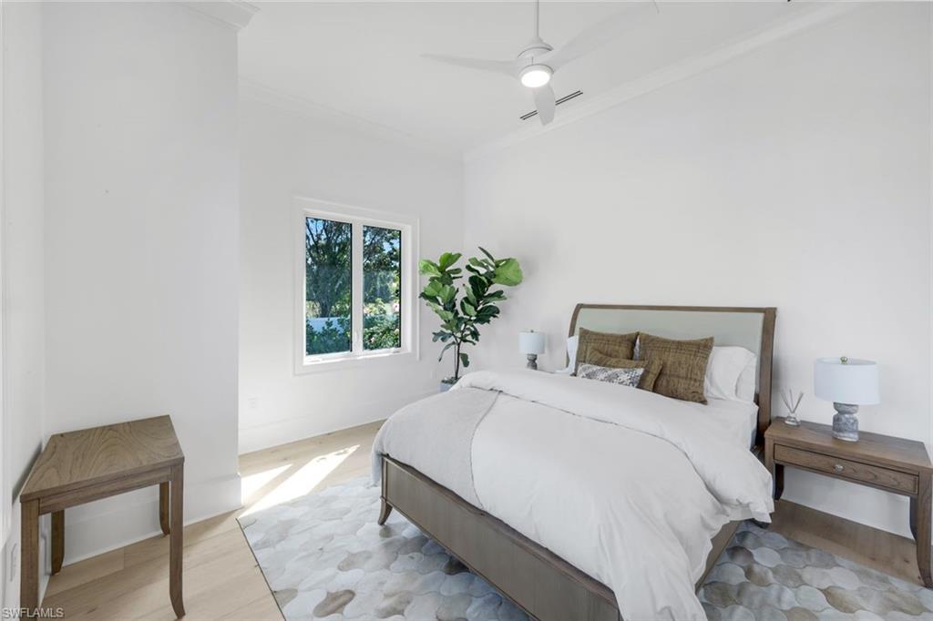 3136 Ravenna Avenue Naples, FL 34120 - Photo 33 of 50 Bedroom featuring wood finished floors, crown molding, ceiling fan, and lofted ceiling