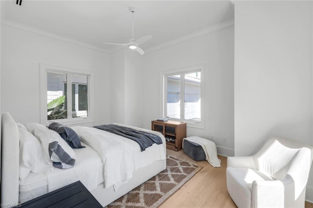 3136 Ravenna Avenue Naples, FL 34120 - Photo 37 of 50 Bedroom featuring crown molding, wood finished floors, and a ceiling fan