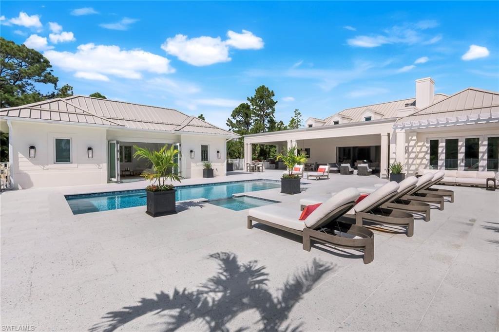 3136 Ravenna Avenue Naples, FL 34120 - Photo 7 of 50 View of swimming pool with a patio, an outdoor living space, and a pool with connected hot tub