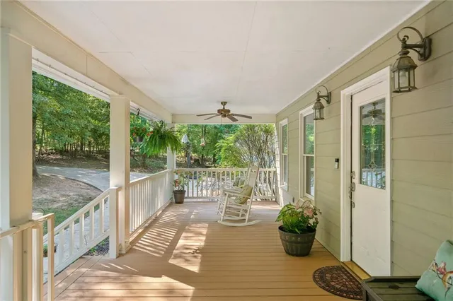 a view of a porch with furniture and wooden floor