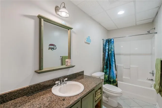 a bathroom with a sink toilet a mirror and shower