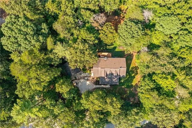 an aerial view of a house with a yard