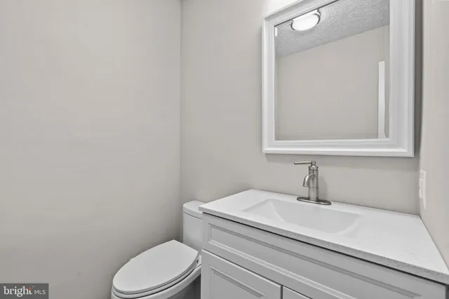 a bathroom with a sink toilet and mirror