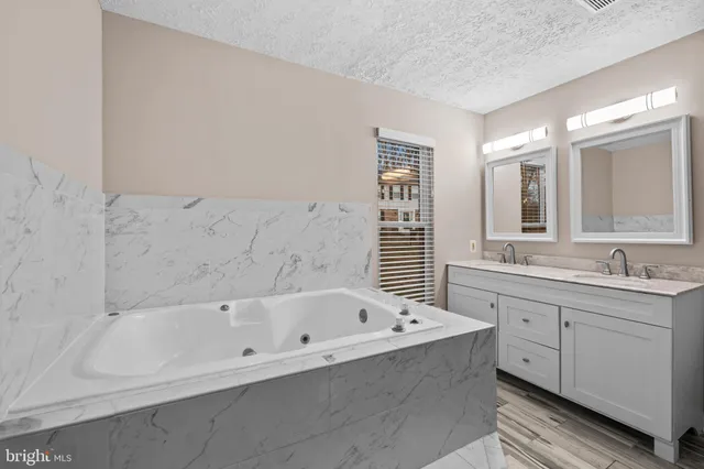 a bathroom with a bathtub and a sink