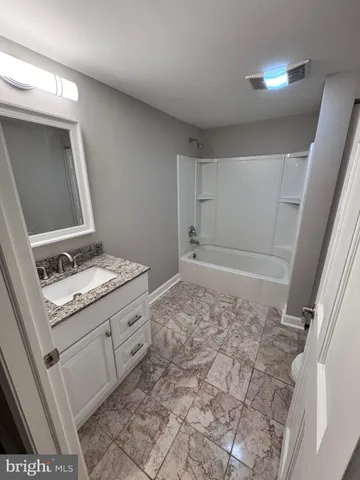 a bathroom with a sink and a stove