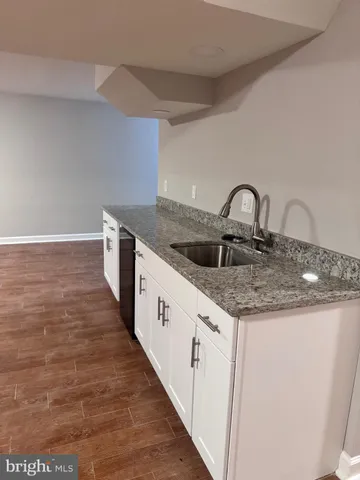 a kitchen with granite countertop a sink and cabinets