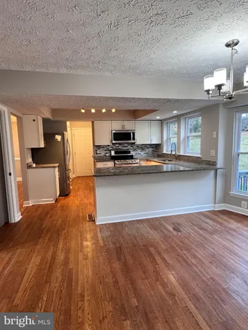 a view of kitchen with wooden floor