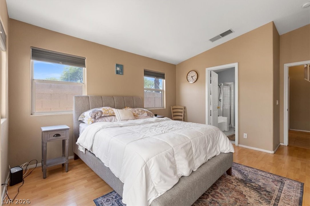 2377 Ramsgate Drive Henderson, NV 89074 - Photo 14 of 25 A restful bedroom offers bright windows and direct access to a private bath.