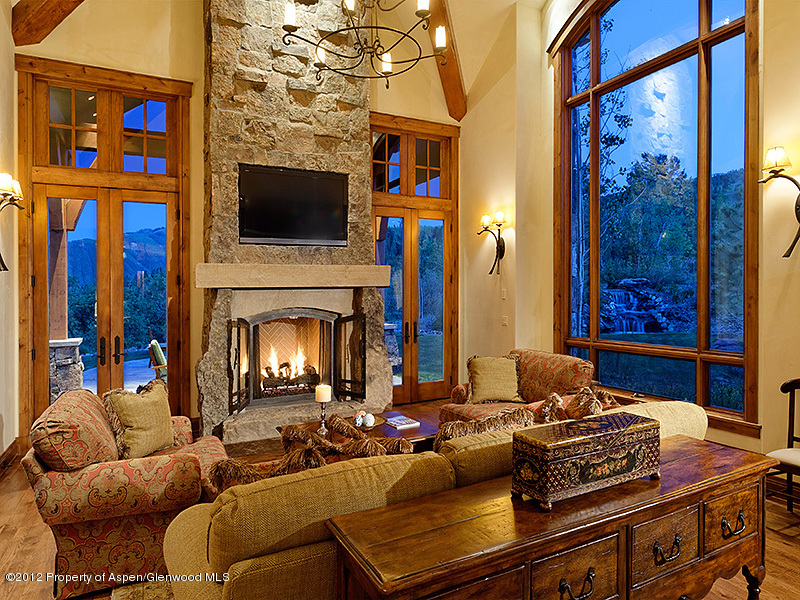 360 Eagle Pines Drive Aspen, CO 81611 - Photo 12 of 40 a living room with furniture a flat screen tv and a fireplace