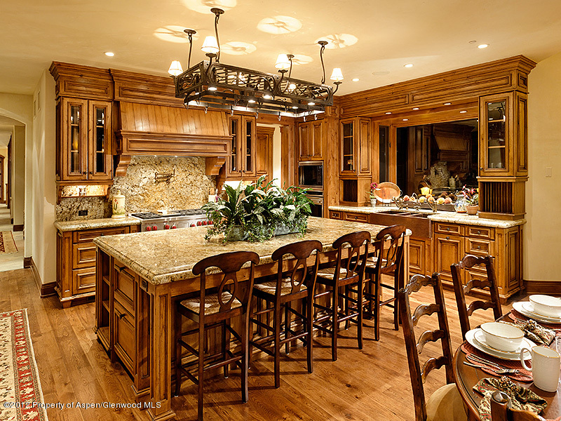 360 Eagle Pines Drive Aspen, CO 81611 - Photo 13 of 40 a view of a dining room and livingroom with furniture wooden floor a chandelier