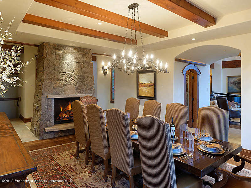 360 Eagle Pines Drive Aspen, CO 81611 - Photo 14 of 40 a living room with furniture a chandelier and a fireplace