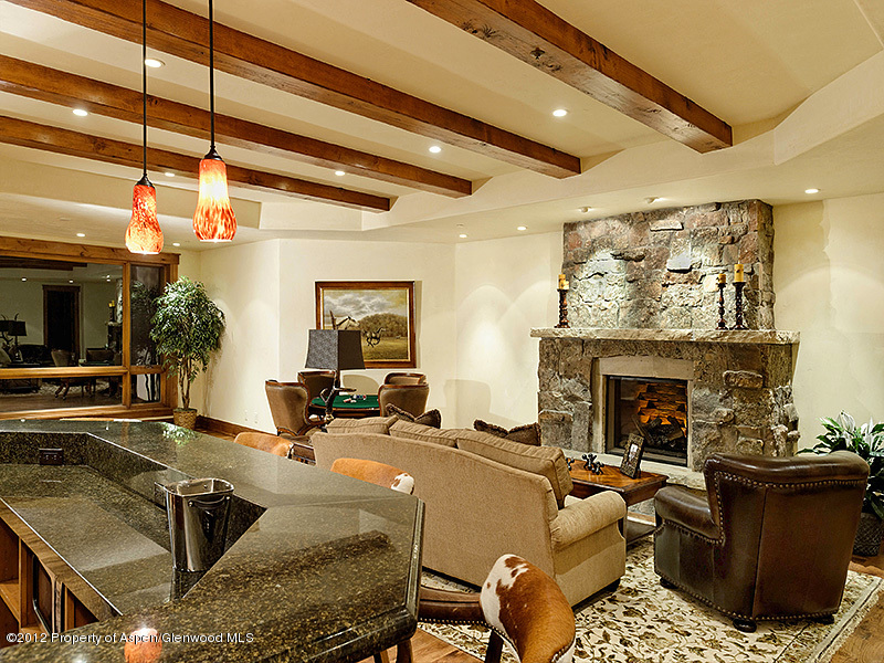 360 Eagle Pines Drive Aspen, CO 81611 - Photo 16 of 40 a living room with furniture and a fireplace