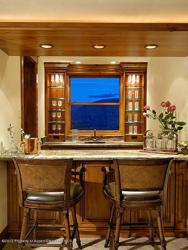 360 Eagle Pines Drive Aspen, CO 81611 - Photo 17 of 40 a view of a kitchen with dining table and chairs