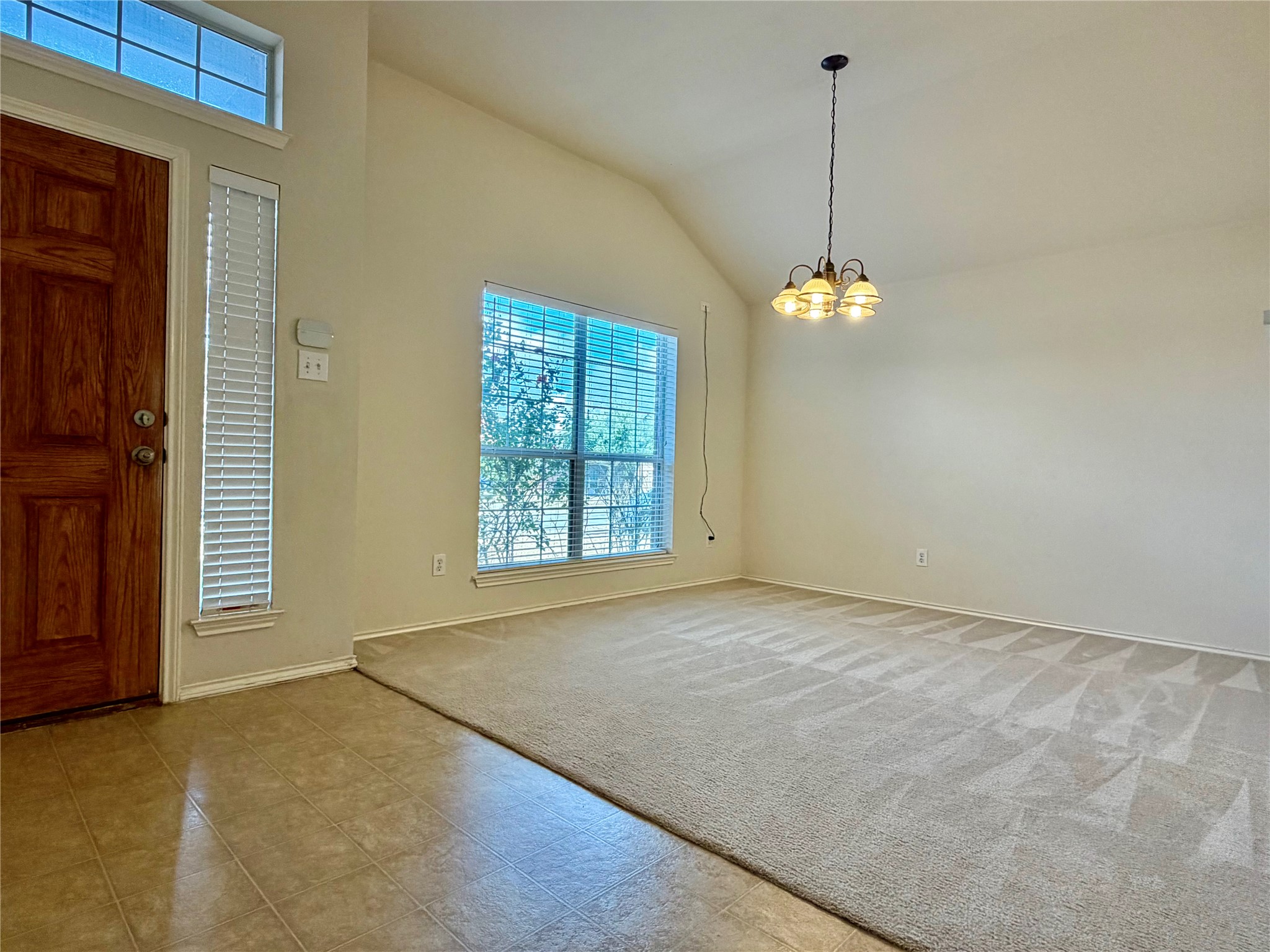1817 Rachel Lane Round Rock, TX 78664 - Photo 3 of 25 a view of an empty room with window and chandelier fan