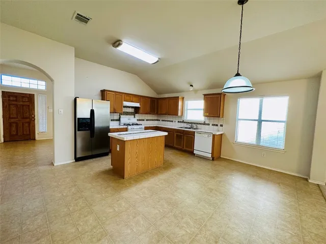 a large kitchen with cabinets and stainless steel appliances