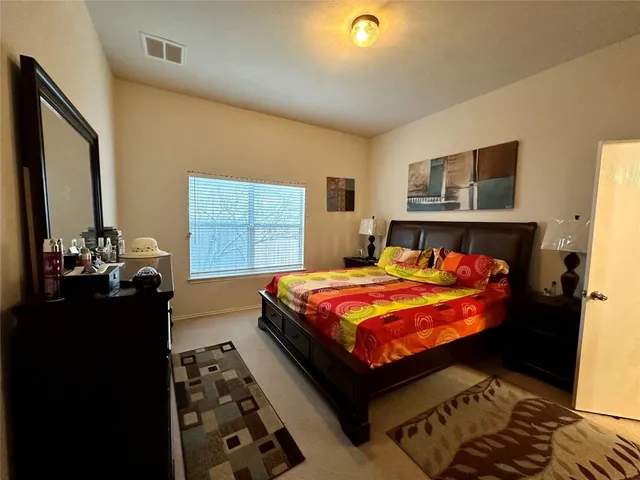 a bedroom with a bed and window