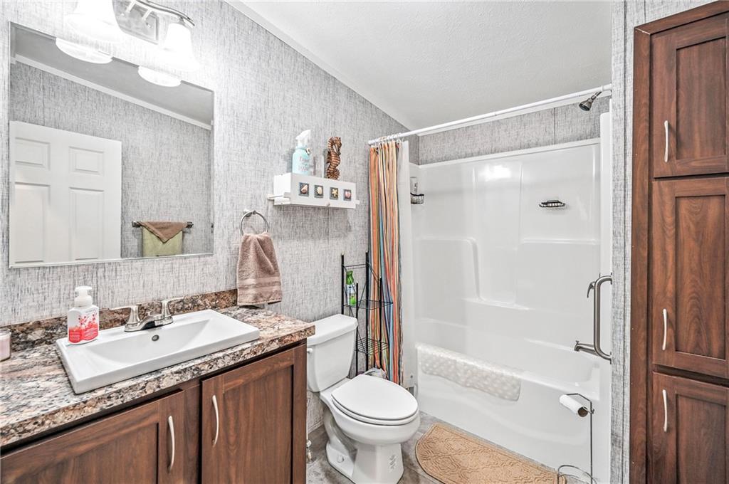 73 South Summit Road, Unit 503 Greenville, PA 16125 - Photo 21 of 36 a bathroom with a granite countertop sink toilet and shower