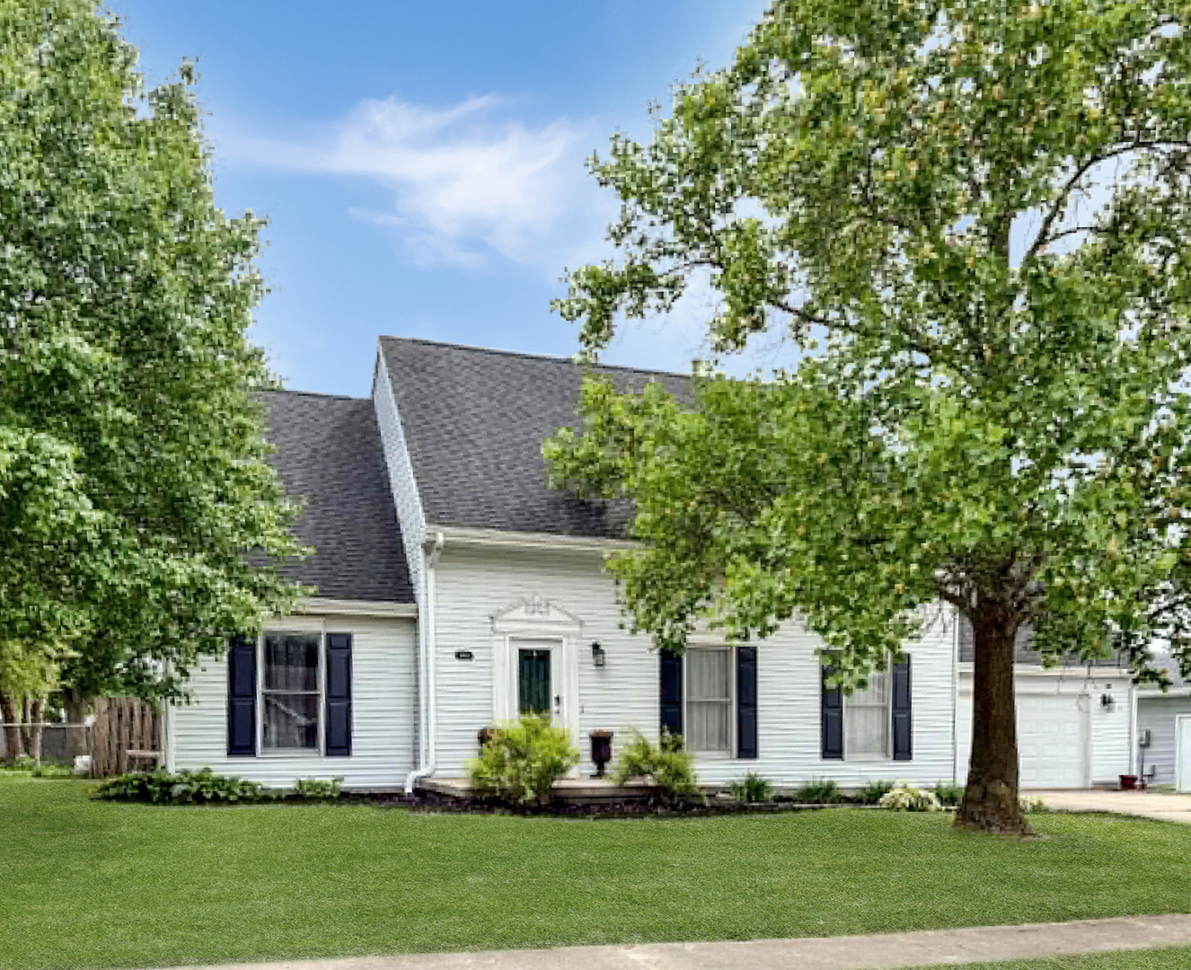 1008 Ascot Drive Rantoul, IL 61866 - Photo 2 of 24 a front view of a house with a garden and trees
