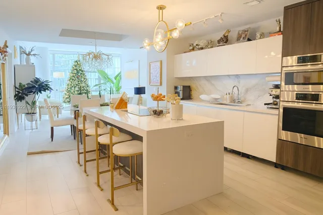 a kitchen with a sink and a large mirror