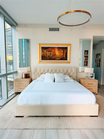 a bedroom with a bed and a mirror