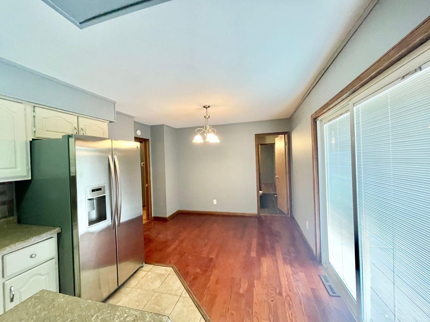 5201 Harrison Street Gary, IN 46410 - Photo 3 of 11 a view of a kitchen with refrigerator and wooden floor