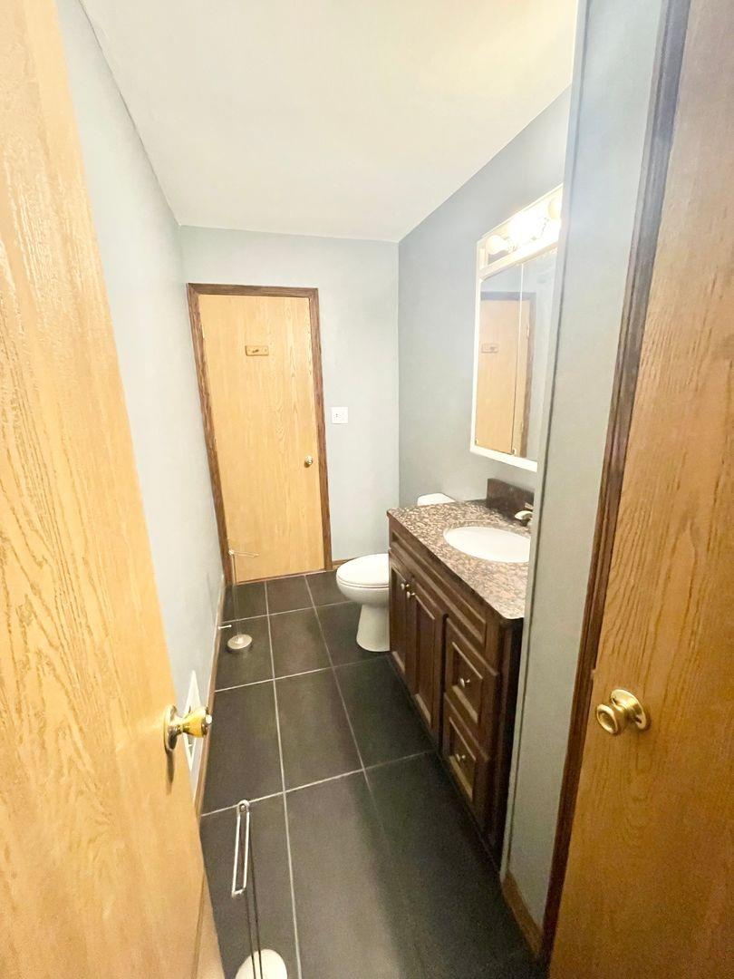 5201 Harrison Street Gary, IN 46410 - Photo 8 of 11 a bathroom with a sink a toilet and a mirror