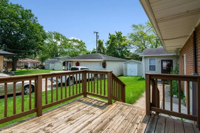 a view of a wooden deck and a yard