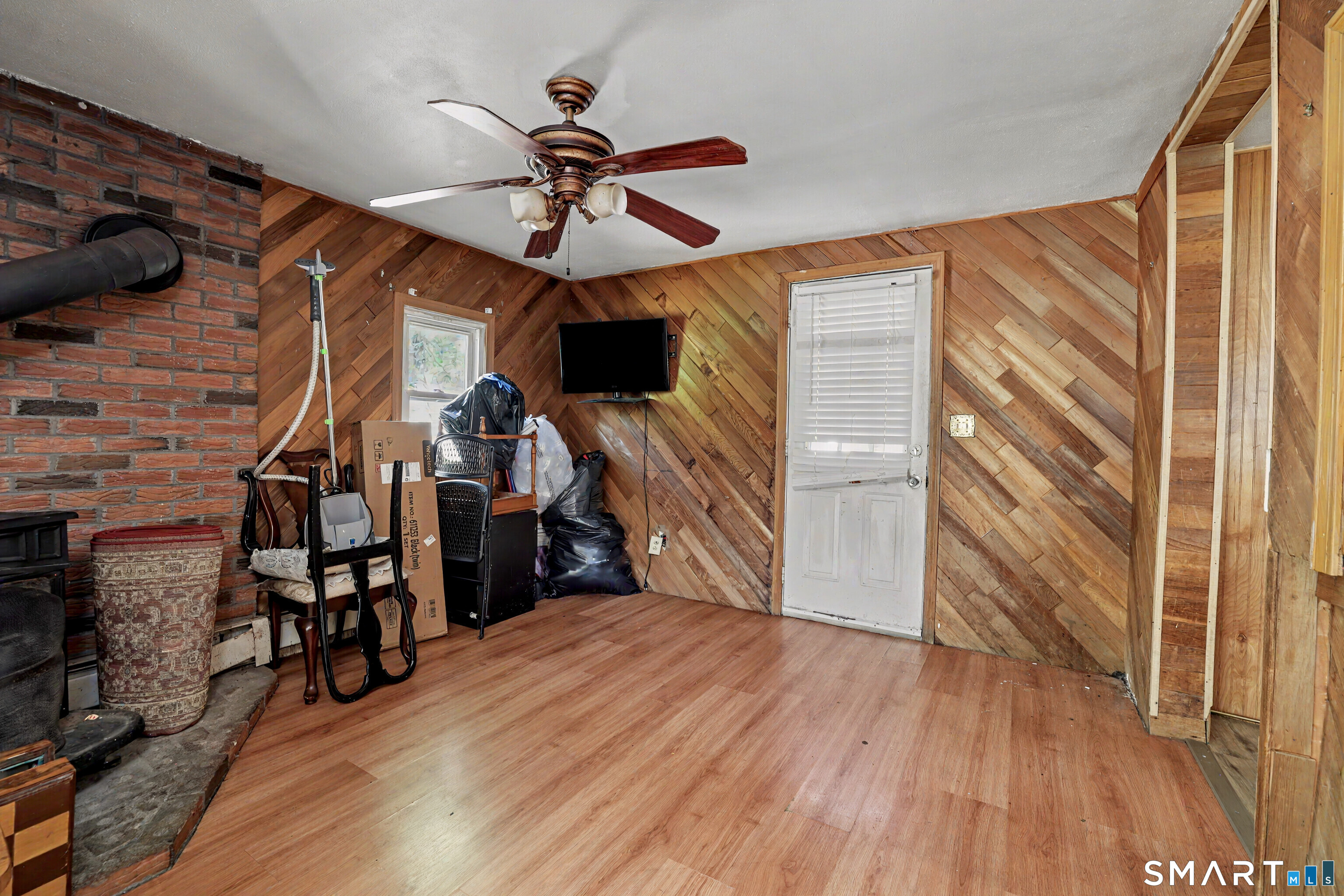 97 Boothbay Street Bloomfield, CT 06002 - Photo 15 of 33 a view of a livingroom with wooden floor and a ceiling fan