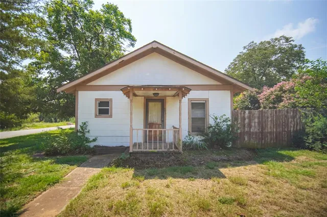 a view of a house with yard and a garden