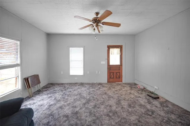 a view of room with window and ceiling fan
