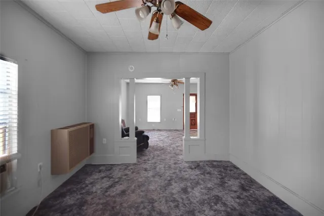 a view of empty room with ceiling fan