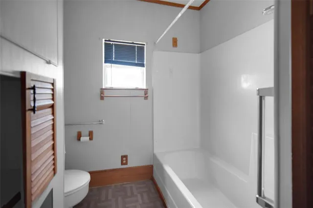 a bathroom with a bathtub and a toilet