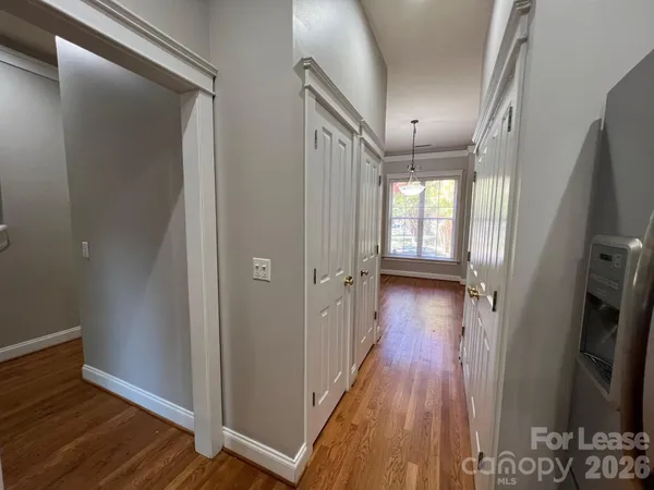a kitchen with stainless steel appliances granite countertop a sink a stove and a wooden floors