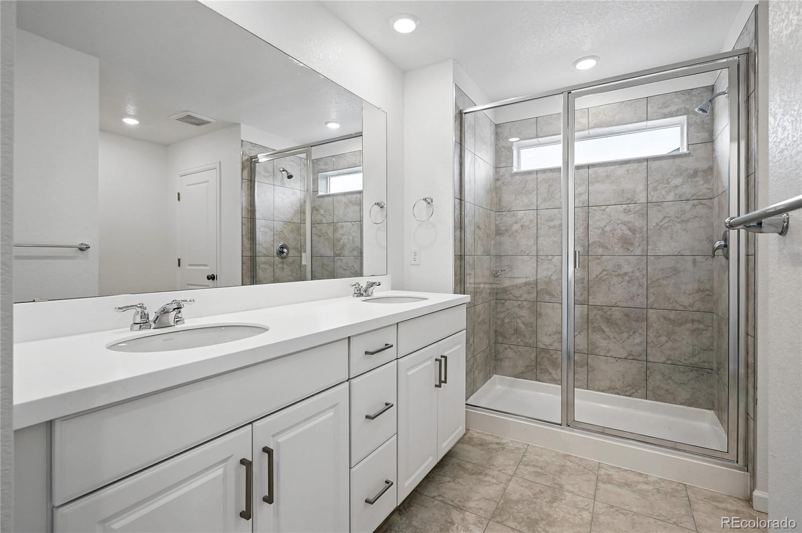 39713 Penn Road Elizabeth, CO 80107 - Photo 14 of 32 a bathroom with a shower sink and mirror