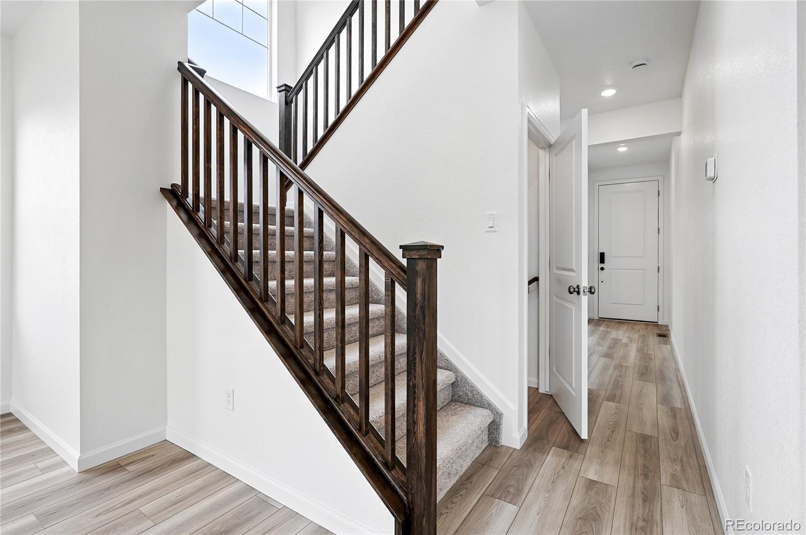 39713 Penn Road Elizabeth, CO 80107 - Photo 15 of 32 a view of a hallway with wooden floor and staircase