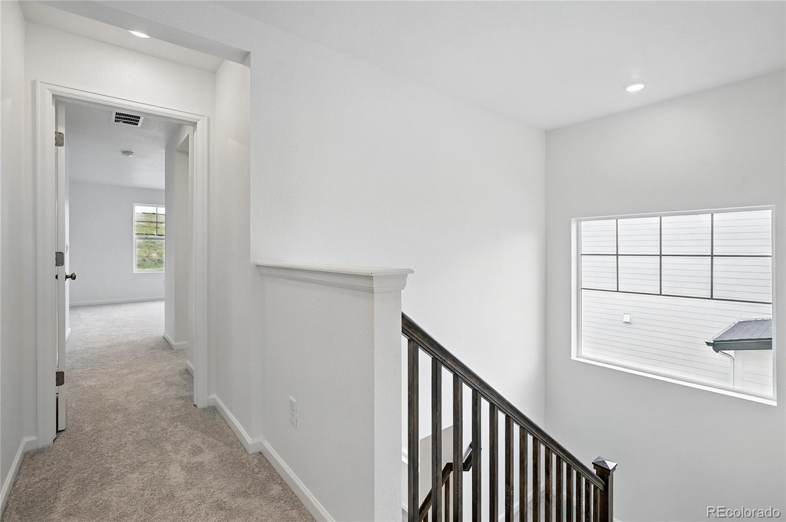 39713 Penn Road Elizabeth, CO 80107 - Photo 16 of 32 a view of a hallway with windows and cabinet