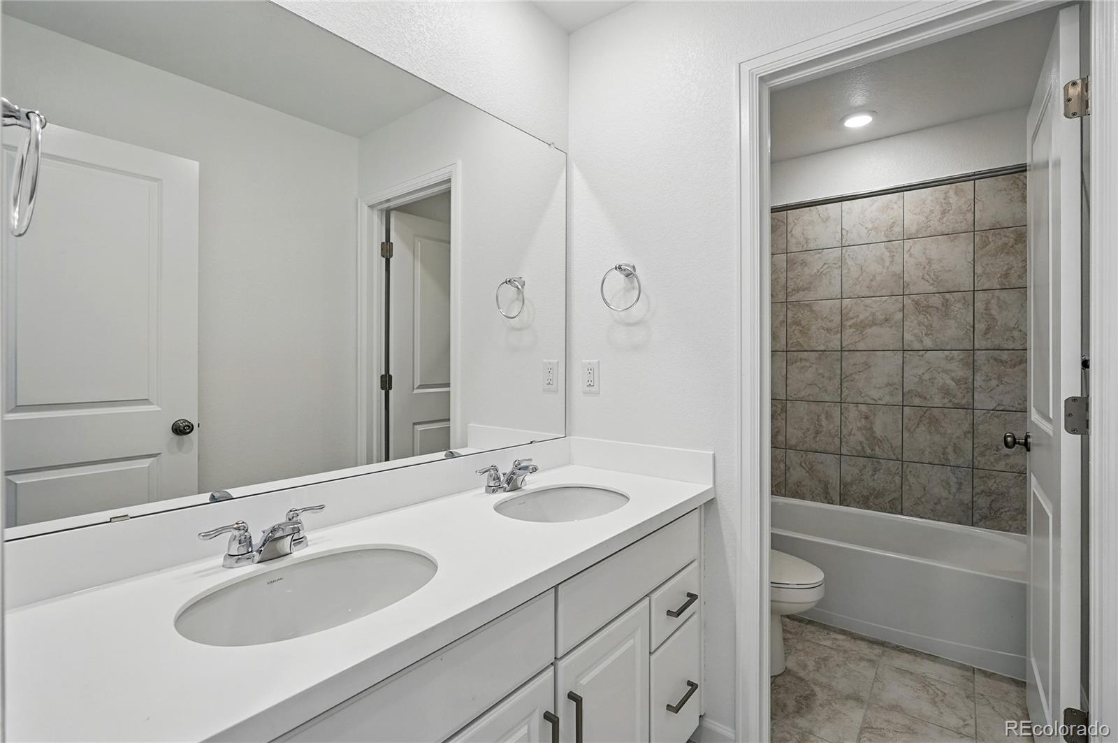 39713 Penn Road Elizabeth, CO 80107 - Photo 19 of 32 a bathroom with a sink double vanity granite tub and shower