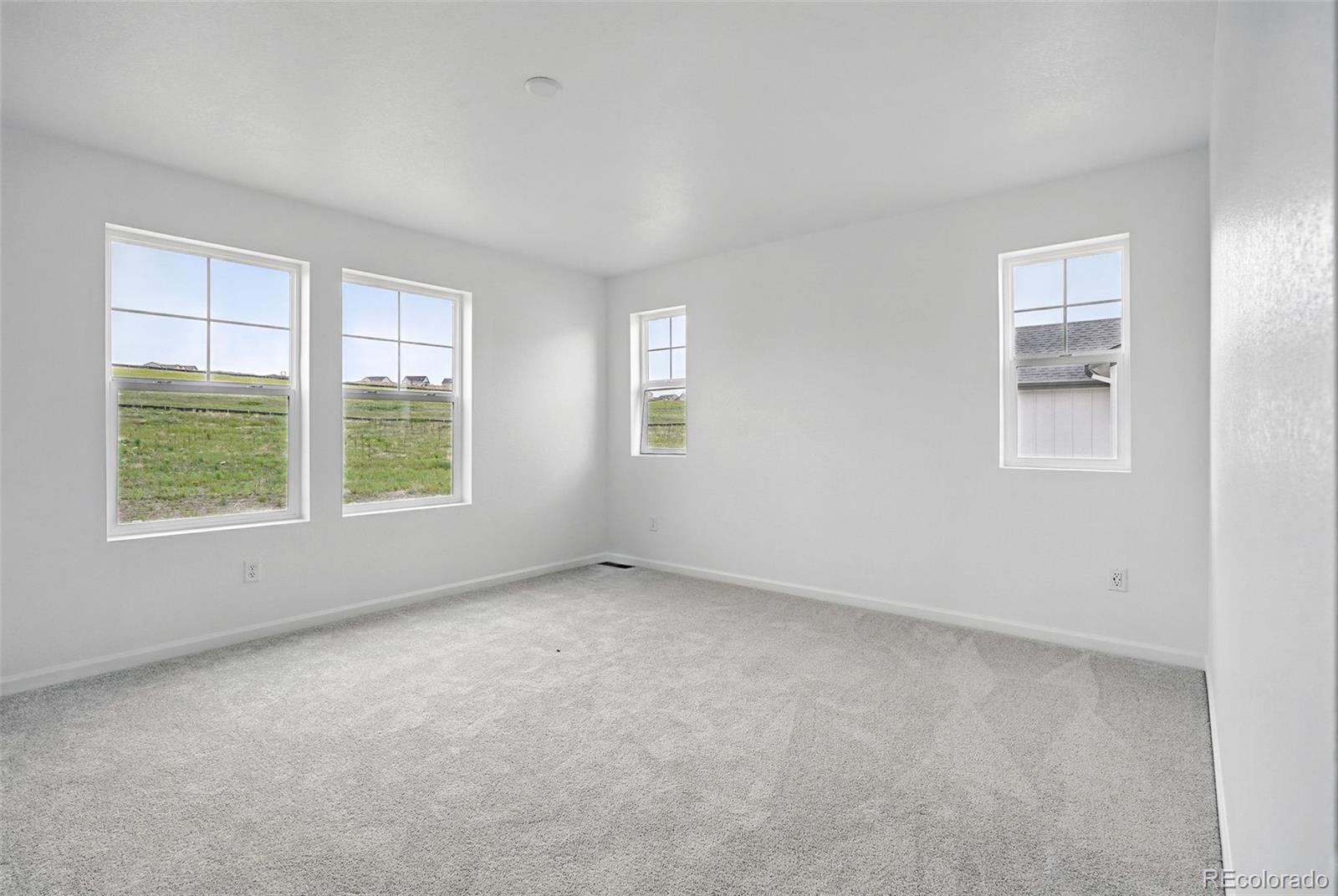 39713 Penn Road Elizabeth, CO 80107 - Photo 5 of 32 an empty room with windows