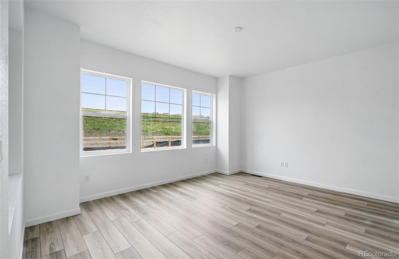 39713 Penn Road Elizabeth, CO 80107 - Photo 6 of 32 a view of an empty room with wooden floor and a window