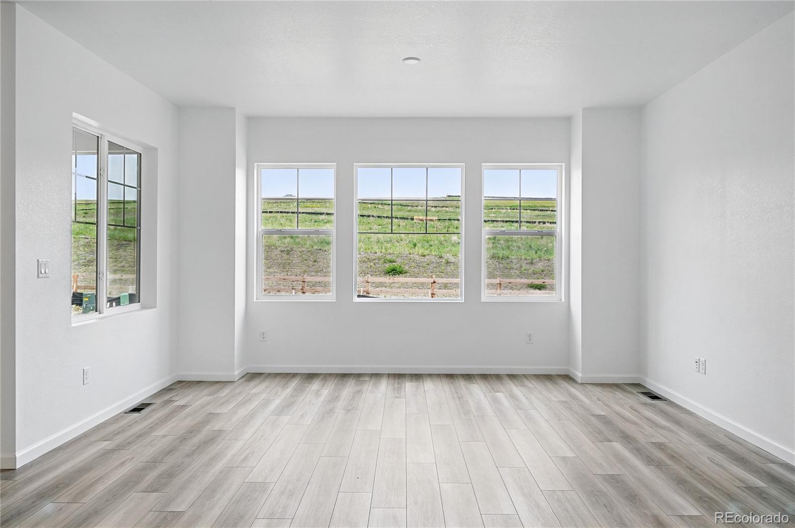 39713 Penn Road Elizabeth, CO 80107 - Photo 7 of 32 a view of an empty room with wooden floor and a window