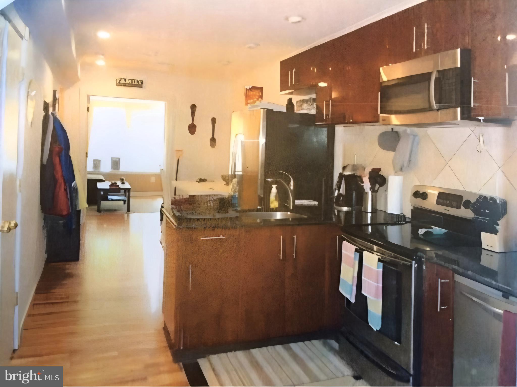 815 South 4th Street Philadelphia, PA 19147 - Photo 8 of 10 a kitchen with stainless steel appliances granite countertop a refrigerator a stove and a microwave