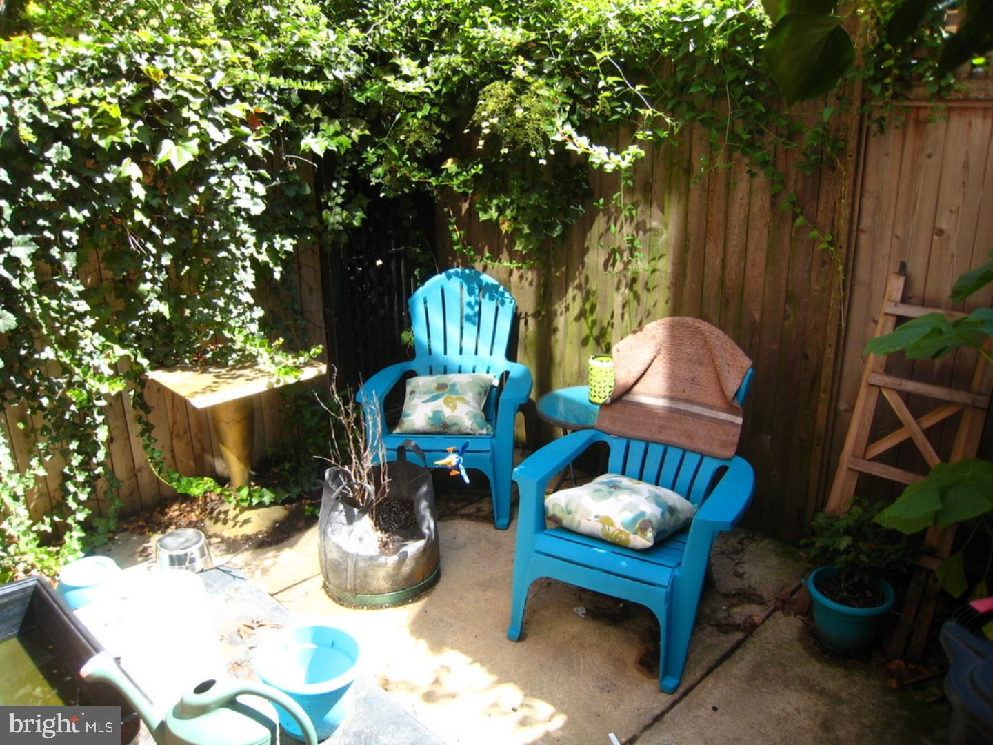 815 South 4th Street Philadelphia, PA 19147 - Photo 10 of 10 a backyard of a house with table and chairs potted plants and a large tree