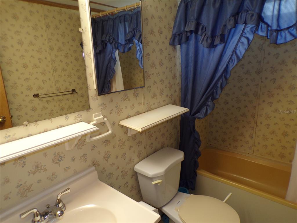 3239 Morrison Way Spring Hill, FL 34606 - Photo 12 of 17 a white toilet sitting next to a bath tub