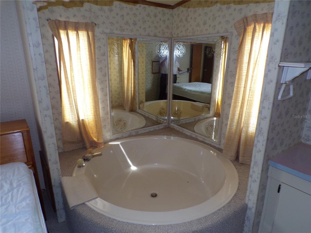 3239 Morrison Way Spring Hill, FL 34606 - Photo 15 of 17 a bathroom with a tub and shower