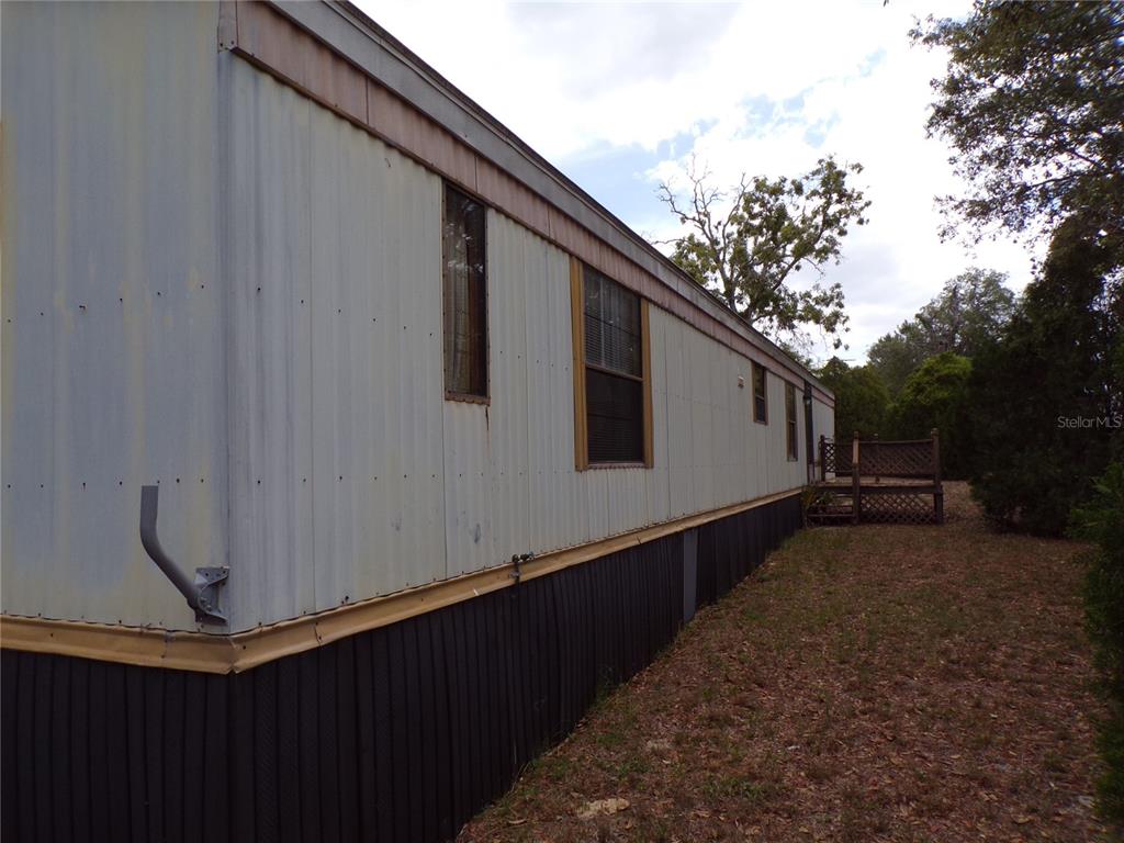 3239 Morrison Way Spring Hill, FL 34606 - Photo 3 of 17 a backyard of a house with wooden fence
