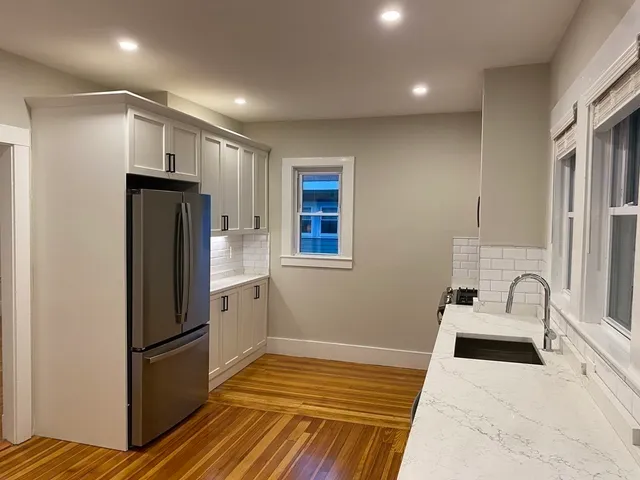 a kitchen with stainless steel appliances a refrigerator and a sink