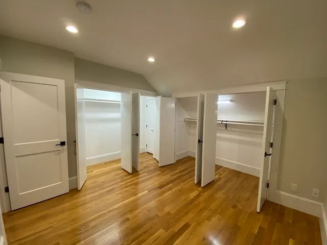 a bathroom with a double vanity sink toilet and shower