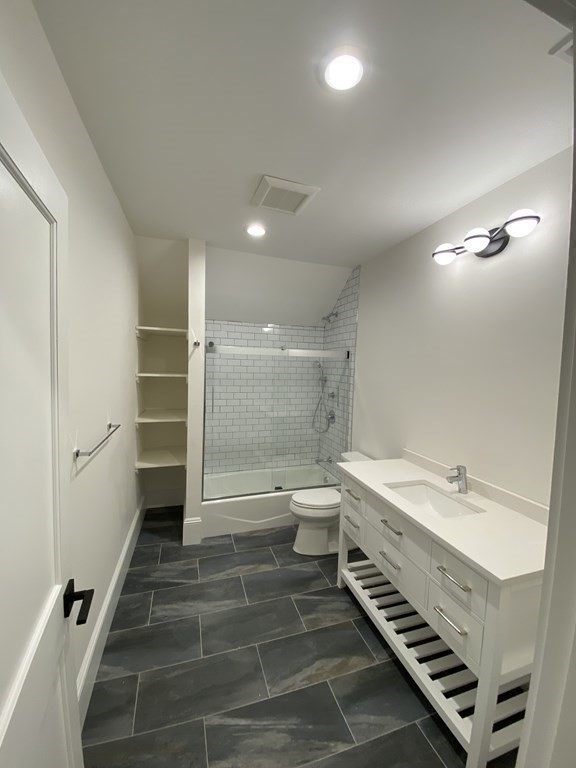 26 Playstead Road, Unit 2 Newton, MA 02458 - Photo 14 of 27 a bathroom with a double vanity sink toilet and shower